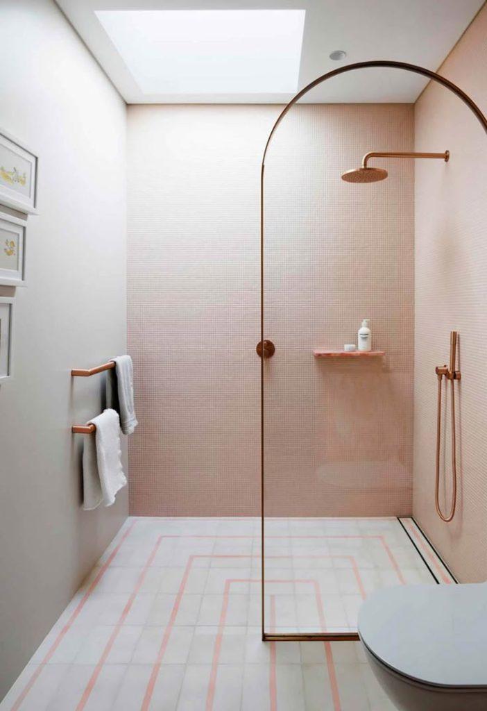 A bathroom showcasing soft pink walls and a well-designed shower, providing a warm and welcoming environment.