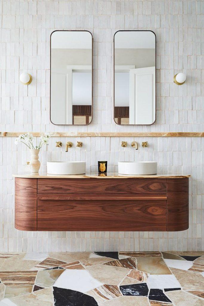 A spacious bathroom featuring two sinks and an elegant marble floor.