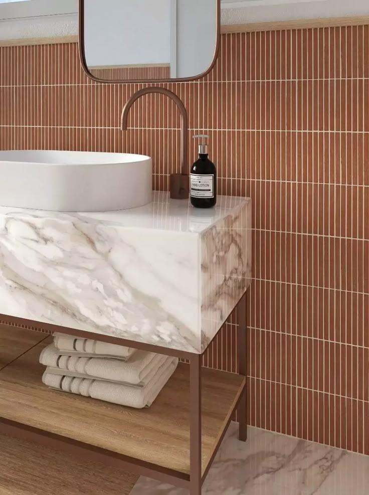 Bright bathroom interior with a luxurious marble sink and a mirror enhancing the ambiance.
