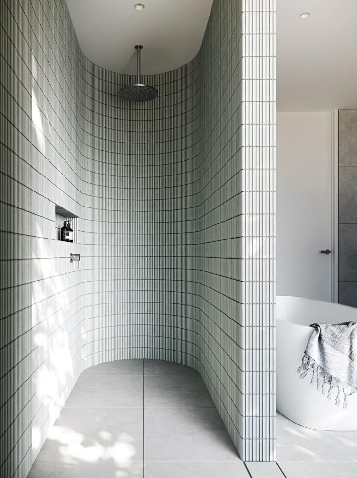 A bathroom featuring a shower and a bathtub, showcasing a clean and modern design.