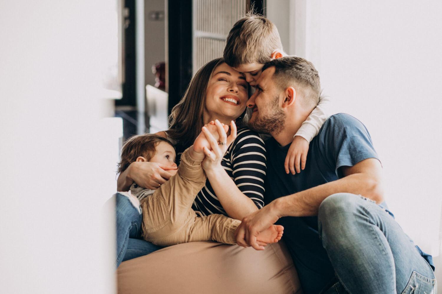 A family sitting together on a couch, engaged in conversation and enjoying quality time.
