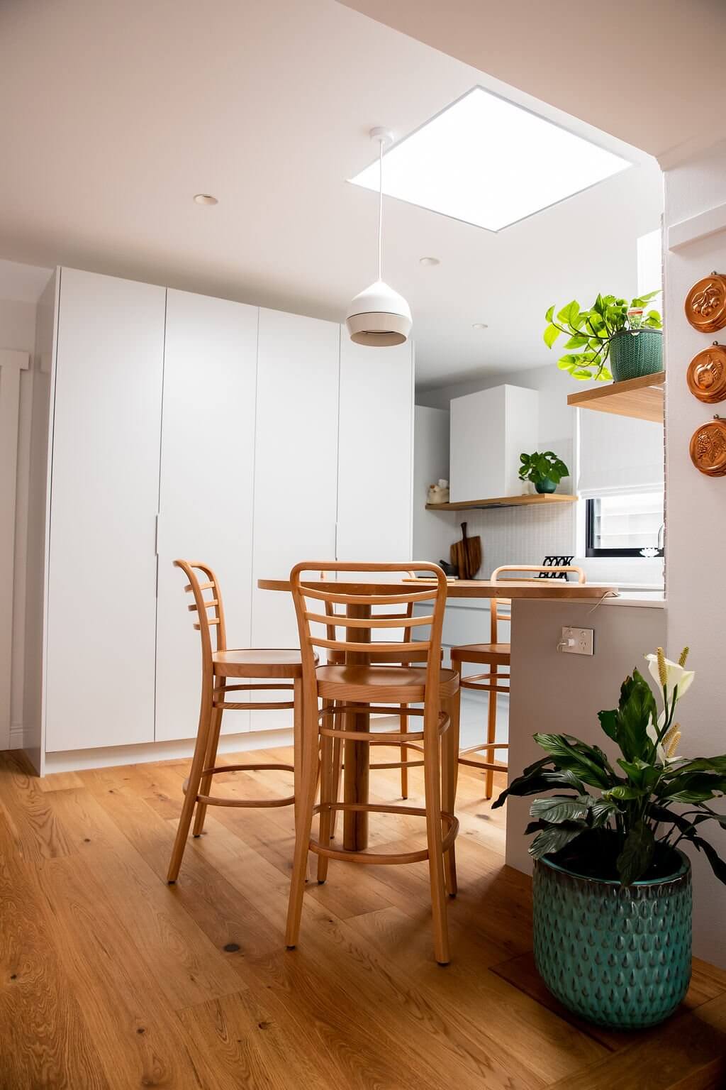 A stylish kitchen with polished wooden floors and a skylight, offering a bright and inviting cooking space.