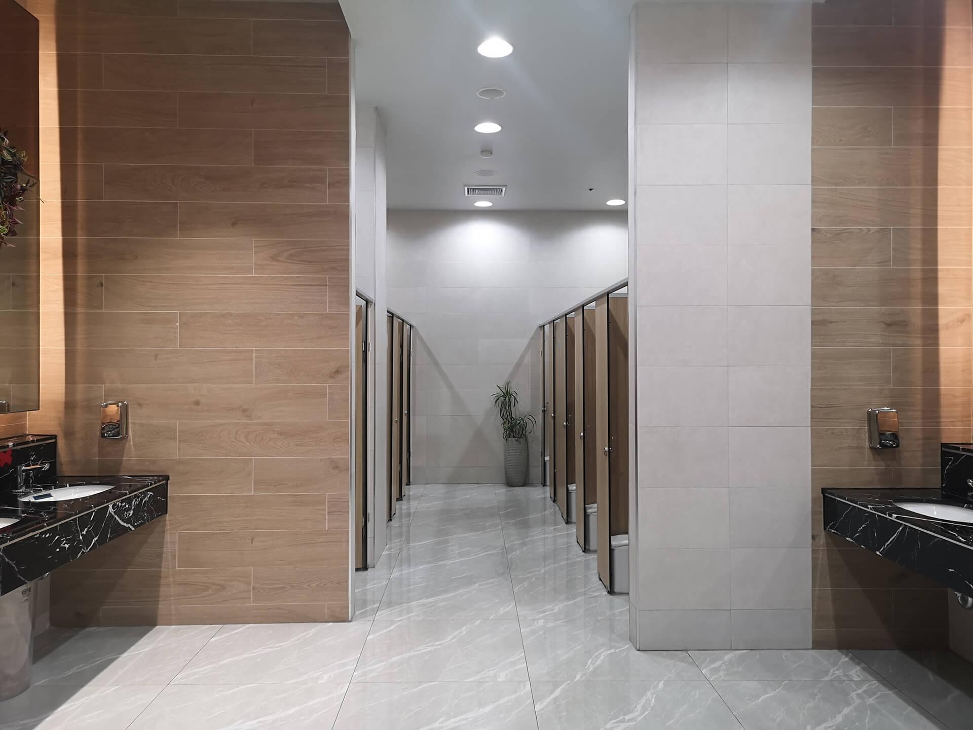 A clean bathroom interior with two sinks and a large mirror on the wall.
