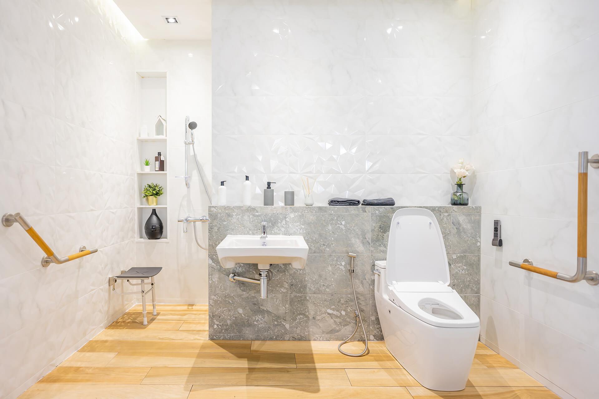 A bathroom featuring a toilet, sink, and shower, designed for functional and comfortable use.