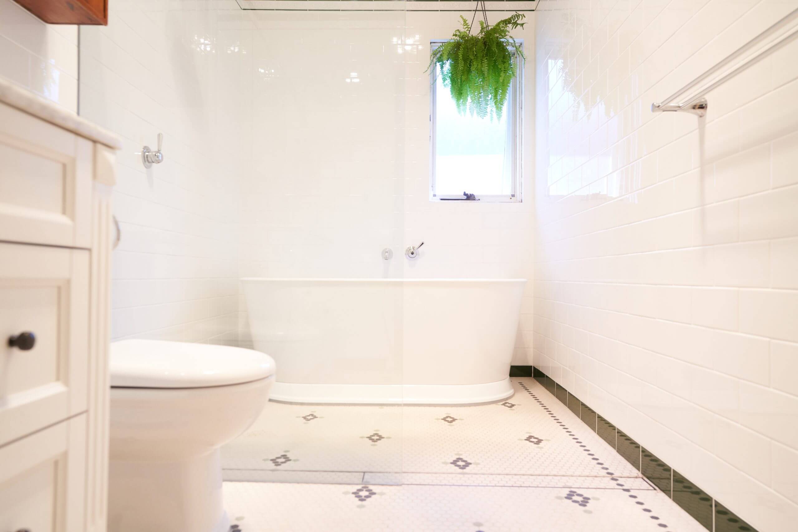 A simple bathroom with a white toilet and sink, showcasing a minimalist design.