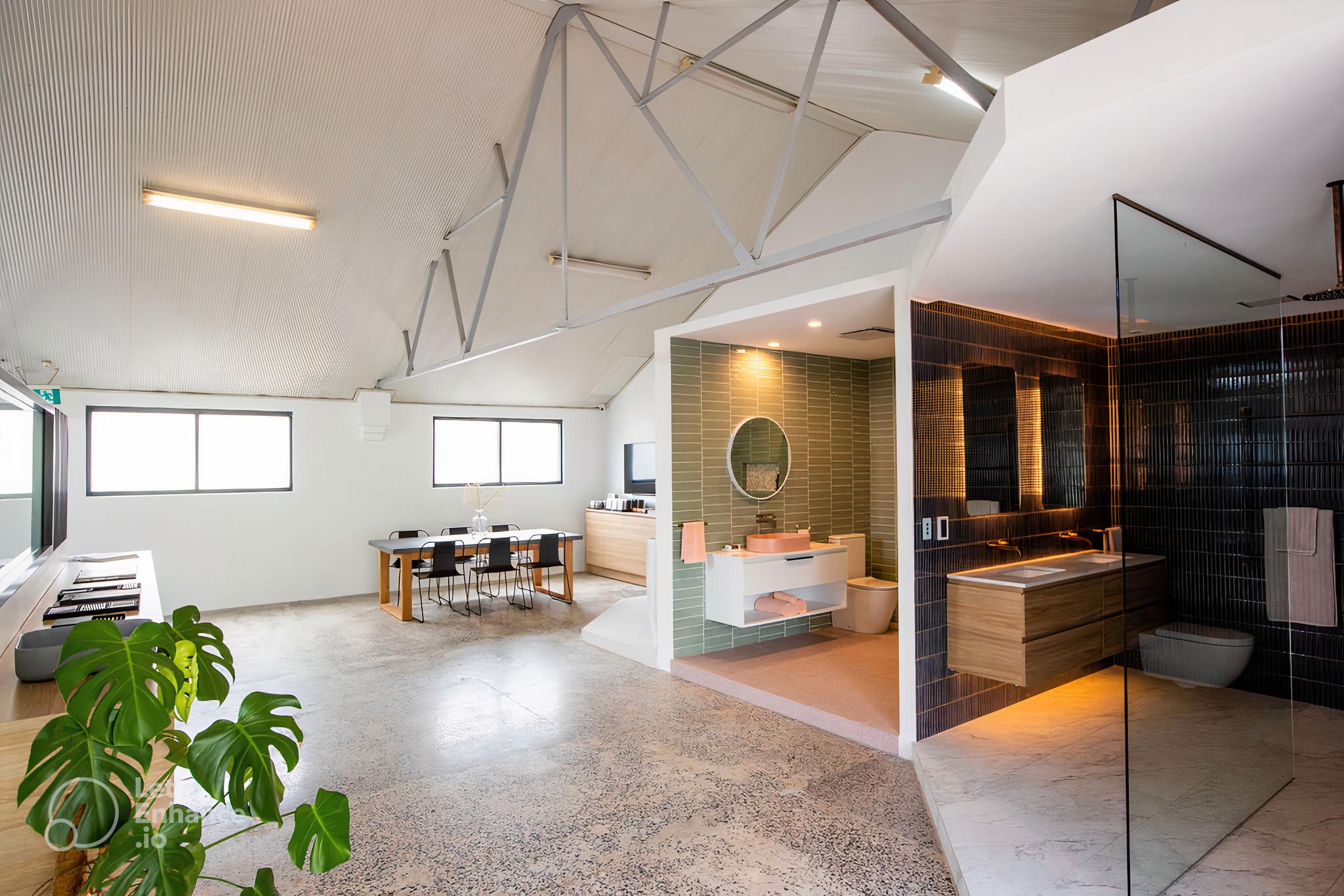Modern Sydney showroom with stylish bathroom displays, open workspace, and polished concrete flooring.
