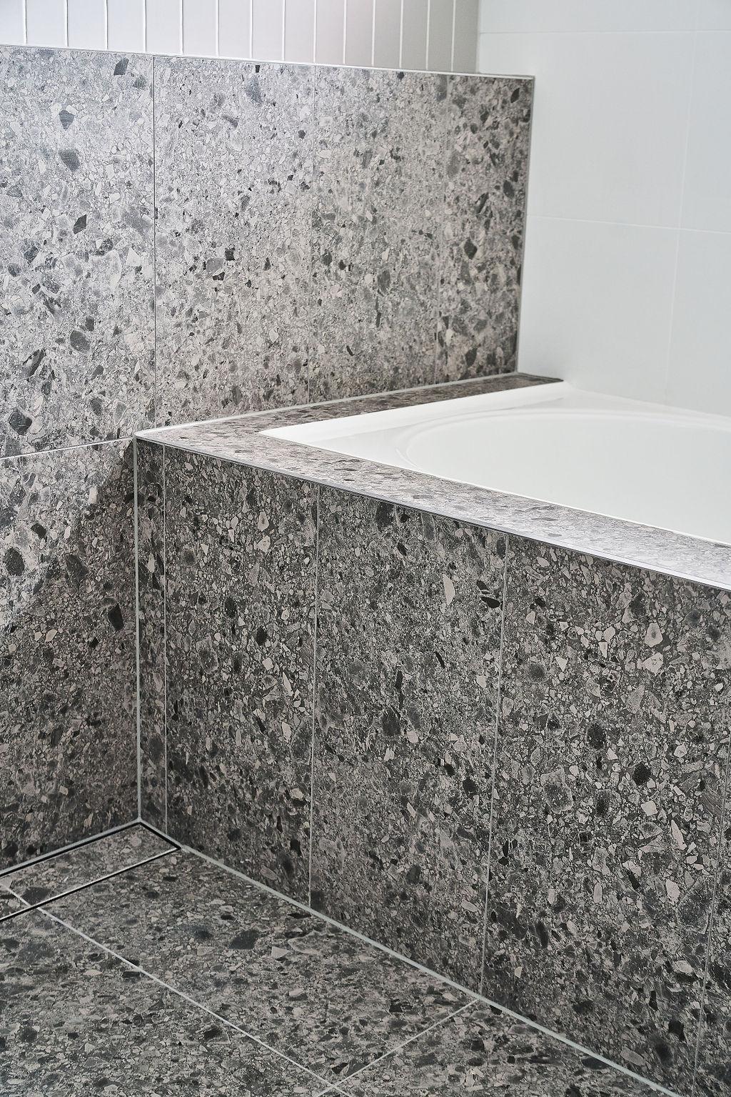 Terrazzo tiled bath ledge with white stone benchtop edge detail